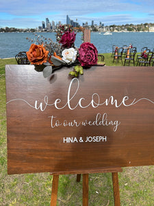 Rustic wooden sign with Mackenzie floral on wooden easel