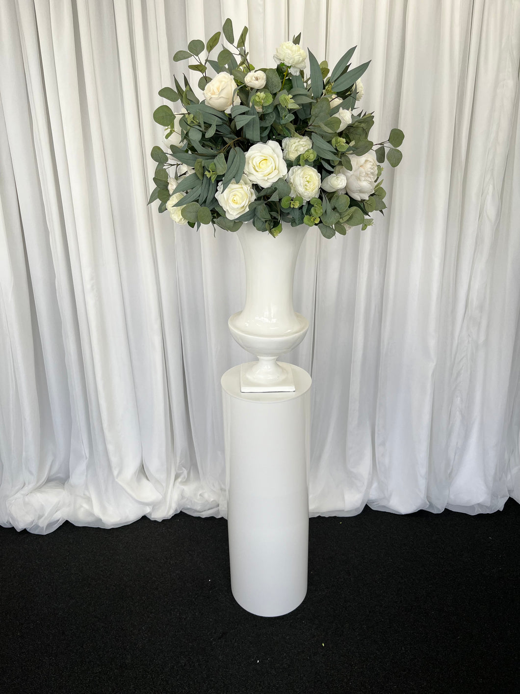 White round cylinder plinth with slimline urn & Sarah floral