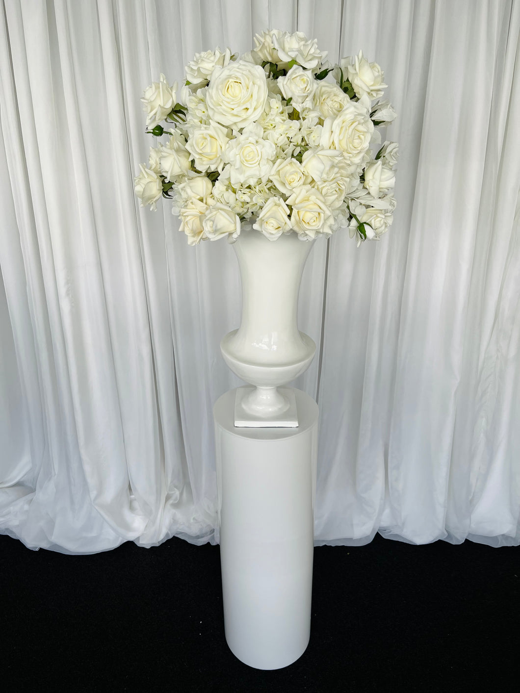 White round cylinder plinth with slimline urn & Eve floral