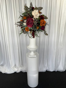 White round cylinder plinth with slimline urn & Mackenzie floral