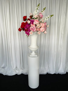 White round cylinder plinth with slimline urn & Lola floral