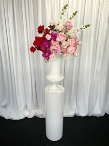 White round cylinder plinth with slimline urn & Lola floral