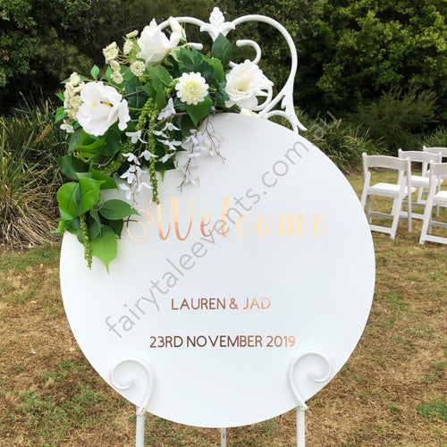 White Round Sign With Ann Floral On White Easel